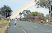  ?? Picture: FILE ?? UNDER THE RAINBOW: Runners in an earlier Twizza Bonkolo marathon head for the finish line at the dam