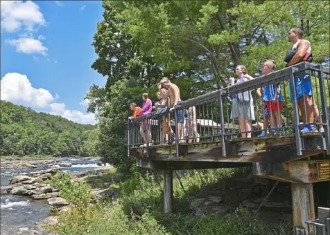  ?? Matt Freed/Post-Gazette ?? Visitors take in a view of Ohiopyle Falls on Monday at Ohiopyle State Park in Ohiopyle.