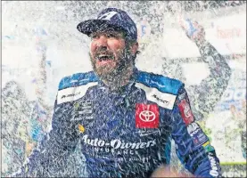  ?? [AP PHOTO/STEVE HELBER] ?? Martin Truex Jr. is doused with water and confetti after winning a NASCAR Cup Series race at Martinsvil­le Speedway, in Martinsvil­le, Va., on Sunday.