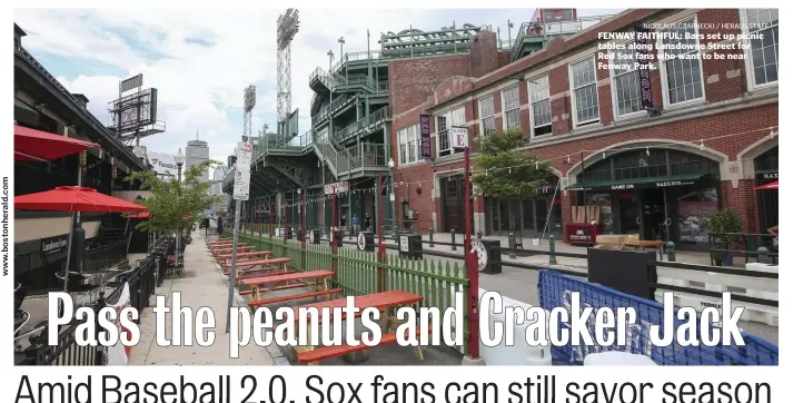  ?? NICOLAUS CZARNECKI / HERALD STAFF ?? FENWAY FAITHFUL: Bars set up picnic tables along Lansdowne Street for Red Sox fans who want to be near Fenway Park.