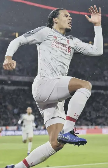  ??  ?? 0 Virgil van Dijk leaps with joy after his header put Liverpool 2-1 ahead against Bayern Munich.