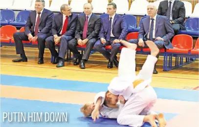  ?? Picture: Reuters ?? Russian President Vladimir Putin listens to officials while watching an exhibition at a local martial arts academy in Cherepovet­s, Russia, yesterday.