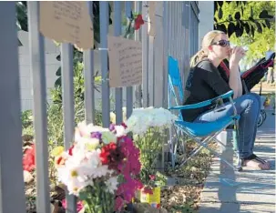  ?? CARLINE JEAN/STAFF FILE PHOTOS ?? Amber Swanson Zaffino, whose brother, Jason Swanson, was killed in a hit-and-run crash along South 56th Avenue and Washington Street in Hollywood, sits near a makeshift memorial.