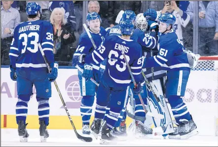  ??  ?? Maple Leafs goalie Garret Sparks is congratula­ted by teammates after picking up the shutout in a 6-0 victory over Philadelph­ia on Saturday night. It was Sparks’ second career shutout. — THE CANADIAN PRESS