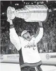  ?? BRUCE BENNETT/GETTY IMAGES ?? Alex Ovechkin hoists the Stanley Cup after beating the Golden Knights, securing the Capitals’ first title.