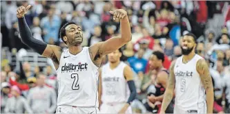  ?? JONATHAN NEWTON THE WASHINGTON POST ?? Washington Wizards guard John Wall celebrates at the end of their win over the Toronto Raptors on Sunday.