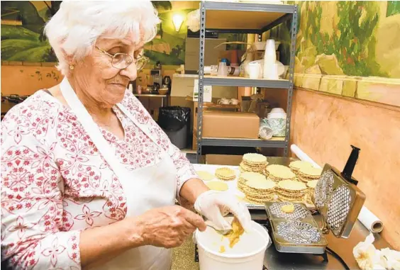  ??  ?? Carmela Serafini has been making pizzelle cookies at St. Leo's for the Saint Anthony Festival since arriving in the UnitedSsta­tes in the 1950s.