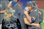  ?? RONALD MARTINEZ / ?? Dodgers’ Justin Turner, right, celebrates after L.A. defeated the Rays 3-1 in Game 6 Tuesday night to win the World Series at Globe Life Field in Arlington, Texas.