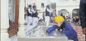  ?? SAMEER SEHGAL /HT ?? A young devotee donating money at the Golden Temple in Amritsar on Friday