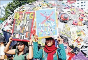  ?? AFP ?? Indonesian environmen­tal activists participat­e in a protest against single-use plastics in the capital Jakarta in July last year.