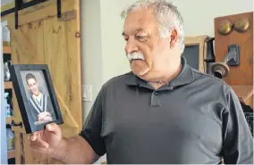  ?? ASHLEY THOMPSON • SALTWIRE NETWORK ?? Carl Baltzer of Centrevill­e, N.S. holds a photo of his youngest son, Andrew. Andrew’s long-drawn battle with problemati­c substance use had led him to many places – rehabs, hospitals and jail.