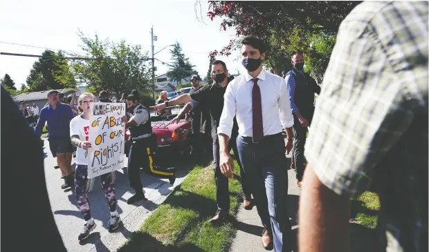  ?? SEAN KILPATRICK / THE CANADIAN PRESS ?? Anti-vaccine protesters like this one in Surrey, B.C., on Wednesday actually work to Justin Trudeau’s benefit, writes John Ivison.