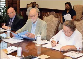  ?? / Doug Walker ?? Accountant Jack Blosky (from left) delivers results of the 2017 audit to the Northwest Georgia Housing Authority board Wednesday. Jim Keaten and Hilda Curtis follow along with his report in their packets.