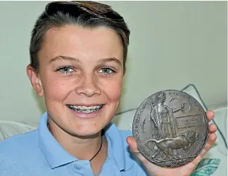  ?? PHOTO: NICHOLAS BOYACK/FAIRFAX NZ ?? Luca Van Dillen did not realise the significan­ce of the World War I memorial plaque he found in his family’s garage until he visited Te Papa. Now he’s keen to learn more about Private James Joseph McGrath.