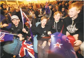  ?? Nick Reed / Associated Press ?? Fans of Emirates Team New Zealand celebrate in Auckland, New Zealand, on Tuesday after the sailing team defeated Oracle Team USA in the America’s Cup in Hamilton, Bermuda.