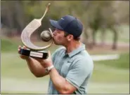  ?? MIKE CARLSON — THE ASSOCIATED PRESS ?? Paul Casey kisses the champion’s trophy after winning the Valspar Championsh­ip golf tournament Sunday in Palm Harbor, Fla.