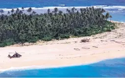  ?? AUSTRALIAN DEFENCE FORCE ?? An Australian Army helicopter lands Sunday on the tiny island of Pikolet, Micronesia, where three stranded sailors were found.