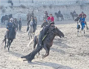  ??  ?? ROUGH AND TUMBLE: Afghan horsemen competing during a game of the traditiona­l sport of buzkashi on the outskirts of Kabul.