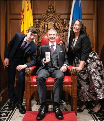  ??  ?? Macroom native Professor Martin Tangney (centre) with his wife Anna and son Cian at his recent OBE presentati­on ceremony in Edinburgh. Photo: Ashley Coombes