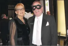  ?? NWA Democrat-Gazette/CARIN SCHOPPMEYE­R ?? Sue and Mark Henneberge­r enjoy the Masquerade.