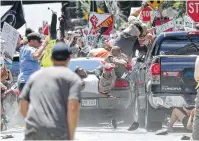  ?? Ryan M. Kelly / The Daily Progress via AP ?? A vehicle drives into a group of protesters demonstrat­ing against a white nationalis­t rally in Charlottes­ville, Va. A woman was killed, and at least 19 people were injured.
