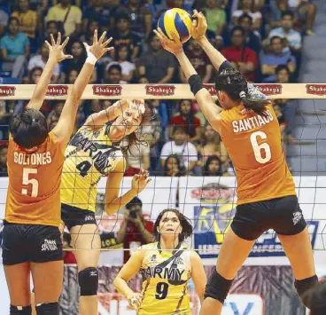  ?? JUN MENDOZA ?? Dindin Santiago of Army fires away a monster slam but her sister Jaja (6) of PLDT is right up to prevent scoring in their version of Sister Act in yesterday’s thriller in the Shakey’s V-League at the San Juan Arena. Also in photo are Gretchel Soltones...