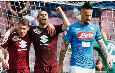  ?? — Reuters ?? Stalemate: Torino’s Lorenzo De Silvestri (centre) celebratin­g after scoring the second goal with Andrea Belotti as Napoli’s Marek Hamsik (right) looks dejected in a Serie A match on Sunday.