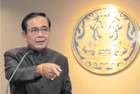  ?? CHANAT KATANYU ?? Prime Minister Prayut Chan-o-cha poses six questions as if to drop hints about his political ambitions.