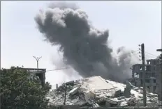  ?? Hussein Malla/Associated Press ?? Black smoke rises from a coalition airstrike July 26 that struck an Islamic State militant position in Raqqa, Syria.