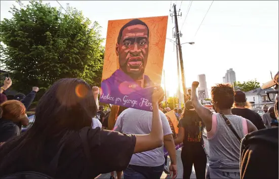  ?? HYOSUB SHIN/HYOSUB.SHIN@AJC.COM ?? Marchers take peacefully to the streets Tuesday in Atlanta moments after former police Officer Derek Chauvin was convicted of killing George Floyd, whose death on a Minneapoli­s street ignited months of racial unrest — even erupting in rioting — in Atlanta and across the nation and beyond.