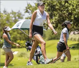 ??  ?? Texas’ Greta Isabella Voelker exits the course Monday after the 18th hole. She shot a first-round 70.