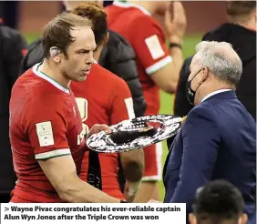  ??  ?? > Wayne Pivac congratula­tes his ever-reliable captain Alun Wyn Jones after the Triple Crown was won