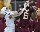  ?? Hannah Foslien / Getty Images ?? LEFT: Minnesota’s Tyler Johnson beats Penn State’s Keaton Ellis for a catch.