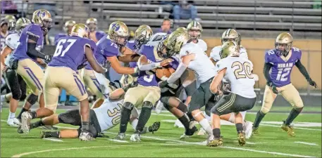  ?? Tim Godbee ?? Calhoun High School Yellow Jacket defenders shut down a run on Friday night against the Hiram Hornets.