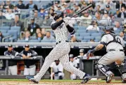  ?? [AP PHOTO] ?? New York Yankees outfielder Giancarlo Stanton hits a tworun homer against the Tampa Bay Rays during the first inning Wednesday in New York.