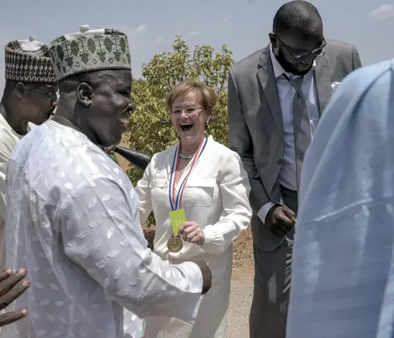  ??  ?? Ensign (at graduation in June) oversees 1,500 students and faculty from 30 nations. She describes Nigeria as “the big challenge” of her life.