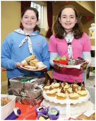  ??  ?? Girl Guides Eimear Murphy and Hannah Walsh serving up some delicious home baking