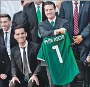  ?? Pedro Pardo AFP/Getty Images ?? MEXICO’S Rafael Marquez, left, presented a World Cup jersey last month to President Enrique Peña Nieto — who himself has been accused of corruption.