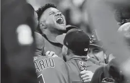  ?? DAVID DERMER AP ?? Cleveland’s Oscar Gonzalez celebrates with teammates following his game-winning home run in the 15th inning of an AL wild-card game Saturday against the Tampa Bay Rays.