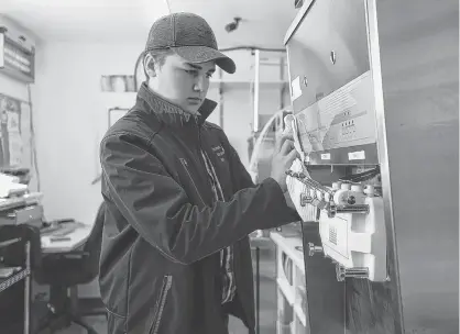  ??  ?? Somerset Ice Cream Bar owner Harrison Duffy wipes down a soft-serve machine as he gets ready to open on May 9. Duffy says he will be taking steps to ensure proper social distancing while customers are waiting and he won't be putting out seating this year. This will be the Kinkora ice cream bar's third summer in business. RYAN ROSS/THE GUARDIAN