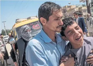  ?? JIM HUYLEBROEK THE NEW YORK TIMES ?? A cousin of the bride grieves after losing his brother in Saturday’s suicide bombing in Kabul.