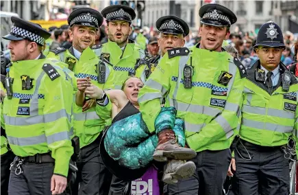  ?? AP ?? Police arrest protesters as they block traffic on London’s Oxford Circus yesterday. The group Extinction Rebellion is calling for a week of civil disobedien­ce against what it says is the failure to tackle the causes of climate change.