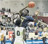  ?? MICHAEL LAUGHLIN/STAFF PHOTOGRAPH­ER ?? Calvary Christian's Jerald Butler passes the ball while guarded by Tampa Catholic's Terrell Strickland.