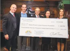  ?? Brian Zuleta ?? The William Raveis Charitable Fund raised a record $552,098 this year for the Damon Runyon Cancer Research Foundation. The Raveis family presented a check to rising CEO of Damon Runyon Yung S. Lie, fourth from the left.