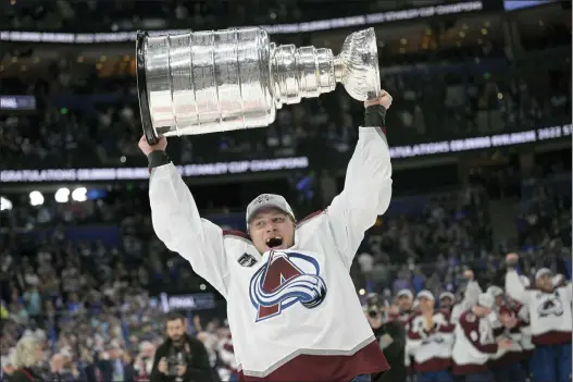  ?? PHELAN EBENHACK — THE ASSOCIATED PRESS ?? Colorado Avalanche defenseman Erik Johnson lifts the Stanley Cup after the team defeated the Tampa Bay Lightning in Game 6 of the Stanley Cup Final.