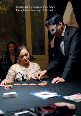  ??  ?? guests get a glimpse of their future through tarot readings at the ball