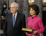  ?? (File Photo/AP/Pool/Samuel Corum) ?? Sen. Mitch McConnell, R-Ky., and his wife, Elaine Chao, wait for McConnell to be sworn in Jan. 3, 2021, during a reenactmen­t ceremony in the Old Senate Chamber at the Capitol in Washington. Stories circulatin­g online incorrectl­y claim Angela Chao, McConnell’s sister-in-law who died in February, had been CEO of the company that owns Dali, the container ship that crashed into Baltimore’s Francis Scott Key Bridge.