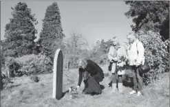  ?? By Naomi Westland for USA TODAY ?? In remembranc­e of her great-uncle: Kath Mackenzie lays flowers at a memorial marker for Alfred Ernest Geer. Geer was a stoker who shoveled coal into the ship’s steam engines. He was given the job aboard Titanic on the day it set out to sea.