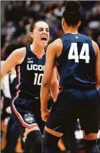  ?? Jessica Hill / Associated Press ?? UConn’s Nika Muhl (10) celebrates with Aubrey Griffin (44) during the first half against North Carolina State on Sunday.