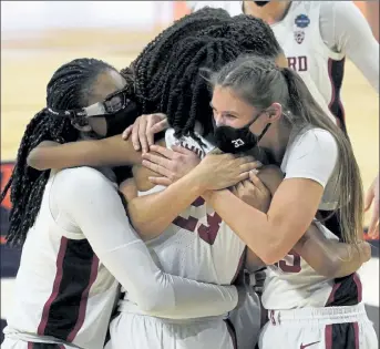  ?? AP PHOTOS ?? Stanford players celebrate after defeating South Carolina in a Final Four matchup on Friday. Below, South Carolina forward Aliyah Boston reacts after the loss.